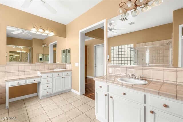 215 Great Gable Dr, Las Vegas, NV 89183 - bathroom featuring a ceiling fan, a shower stall, tile patterned flooring, two vanities, and baseboards