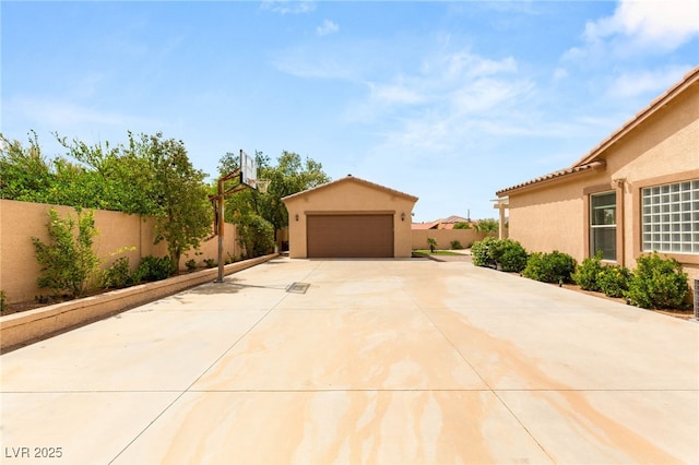 215 Great Gable Dr, Las Vegas, NV 89183 - view of patio featuring fence, an outbuilding, and a garage