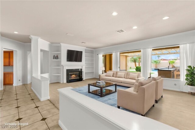 215 Great Gable Dr, Las Vegas, NV 89183 - living room featuring recessed lighting, built in shelves, light tile patterned flooring, a fireplace with flush hearth, and baseboards