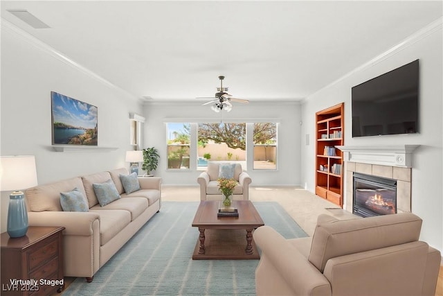 215 Great Gable Dr, Las Vegas, NV 89183 - carpeted living room with ornamental molding, ceiling fan, built in features, a tiled fireplace, and baseboards