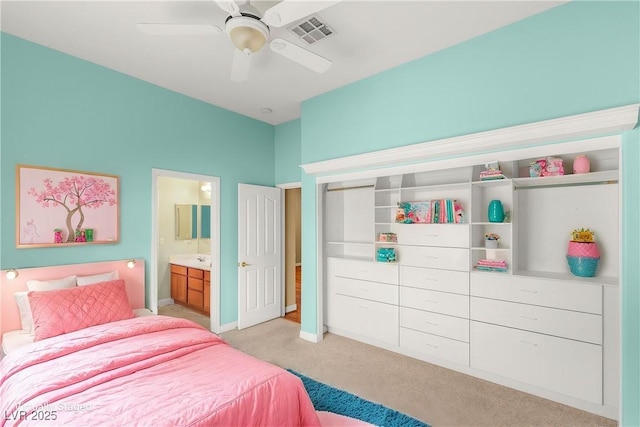 215 Great Gable Dr, Las Vegas, NV 89183 - bedroom featuring light carpet, baseboards, connected bathroom, and a ceiling fan