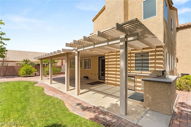 view of patio with an outdoor kitchen, a pergola, and area for grilling