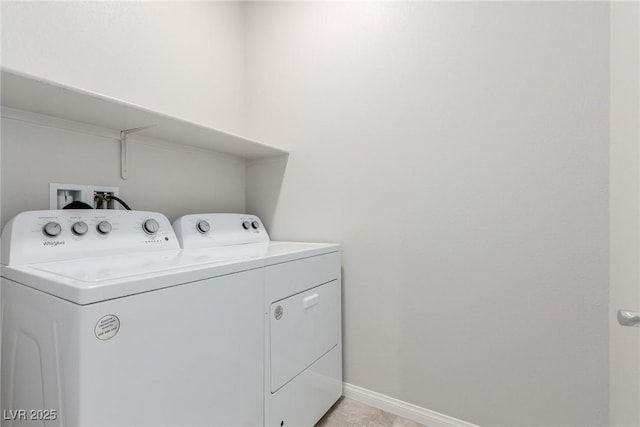 clothes washing area featuring washing machine and clothes dryer and baseboards