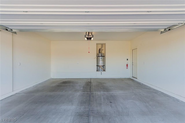garage with a garage door opener and strapped water heater