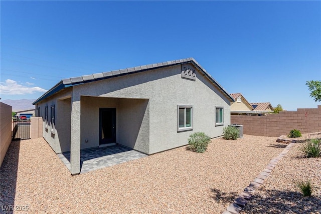 10257 Sequoia Falls Pl, Las Vegas, NV 89149 - rear view of property featuring stucco siding, a fenced backyard, a patio, and central AC unit