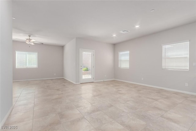 empty room with plenty of natural light, a ceiling fan, baseboards, recessed lighting, and light tile patterned floors