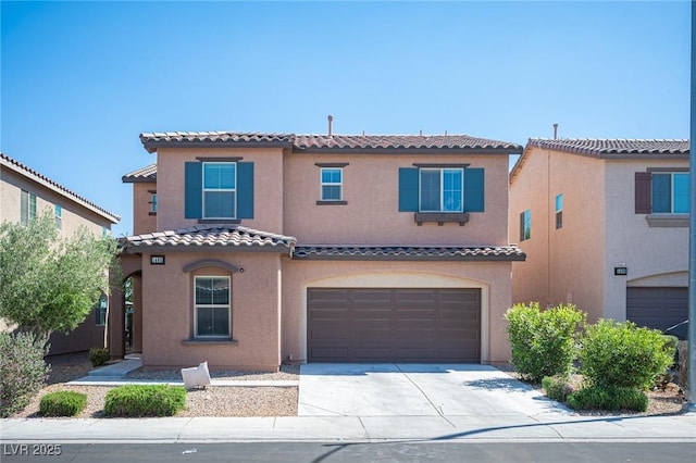 1405 Gilbert Creek Ave, North Las Vegas, NV 89031 - mediterranean / spanish home featuring driveway, a garage, a tiled roof, and stucco siding