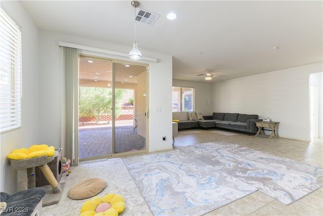 living area featuring tile patterned flooring and a ceiling fan