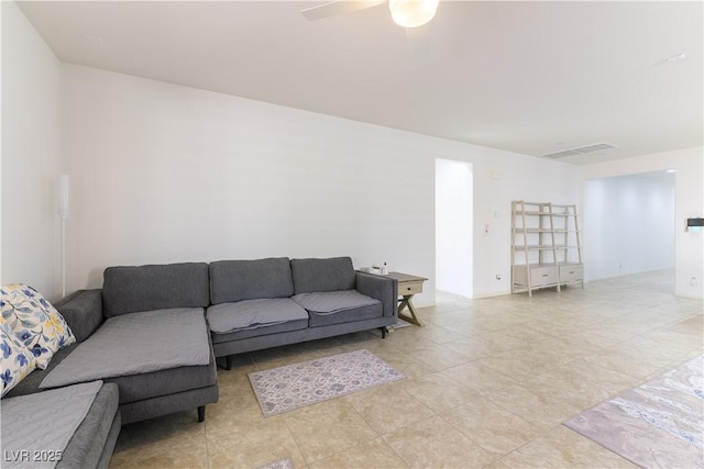 living area featuring light tile patterned floors and a ceiling fan
