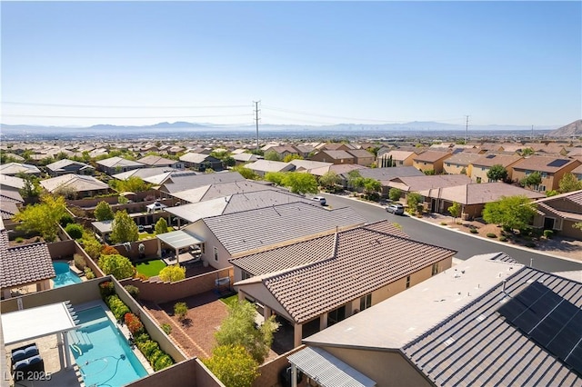 aerial perspective of suburban area with a mountain backdrop and a pool
