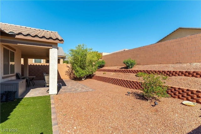fenced backyard with a patio