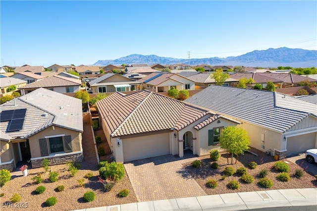 aerial view of residential area featuring a mountainous background