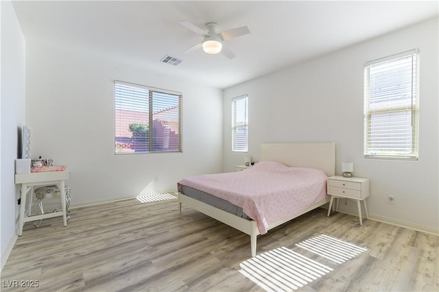 bedroom with wood finished floors, baseboards, and ceiling fan