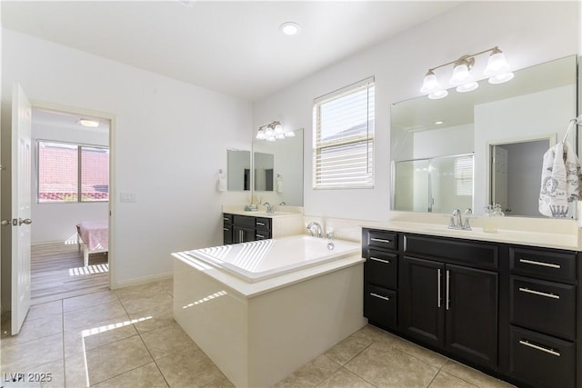 bathroom featuring healthy amount of natural light, tile patterned floors, and connected bathroom
