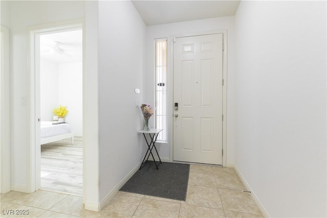 entryway featuring light tile patterned floors and baseboards