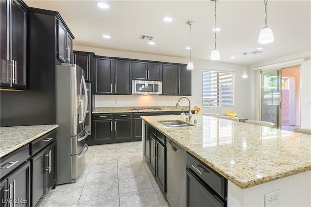 kitchen featuring a sink, appliances with stainless steel finishes, a kitchen island with sink, recessed lighting, and light tile patterned floors