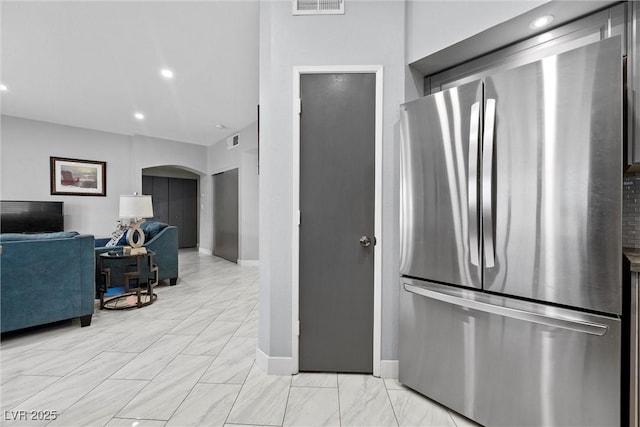 4821 Black Bear Rd Unit 101, Las Vegas, NV 89149 - kitchen with freestanding refrigerator, arched walkways, baseboards, and recessed lighting