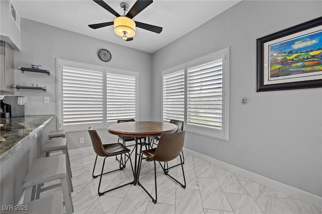 4821 Black Bear Rd Unit 101, Las Vegas, NV 89149 - dining area with a ceiling fan, baseboards, and light marble finish floors