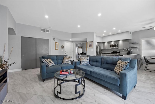 4821 Black Bear Rd Unit 101, Las Vegas, NV 89149 - living room with light marble finish flooring, recessed lighting, baseboards, and a ceiling fan