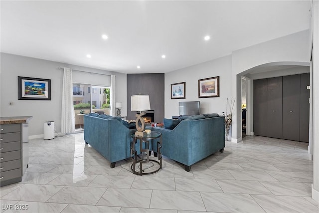 4821 Black Bear Rd Unit 101, Las Vegas, NV 89149 - living area featuring arched walkways, light marble finish floors, recessed lighting, and baseboards