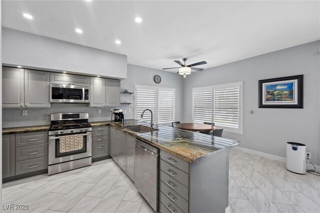 4821 Black Bear Rd Unit 101, Las Vegas, NV 89149 - kitchen featuring stainless steel appliances, gray cabinetry, a sink, light marble finish flooring, and recessed lighting