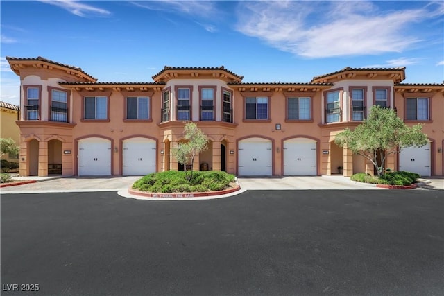30 Via Vasari Unit 102, Henderson, NV 89011 - townhome / multi-family property with stucco siding, a garage, and driveway