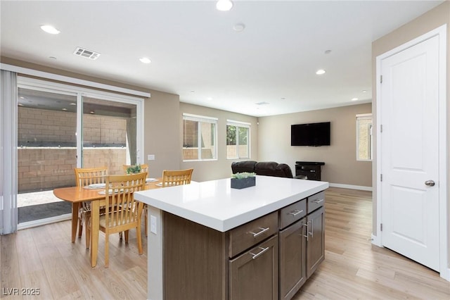 8873 Howell St, Las Vegas, NV 89166 - kitchen featuring light wood-style floors, a kitchen island, light countertops, recessed lighting, and open floor plan