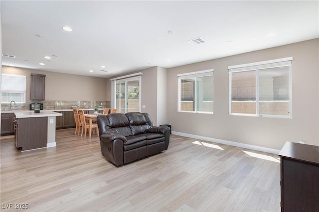8873 Howell St, Las Vegas, NV 89166 - living room featuring light wood-style floors, recessed lighting, and baseboards