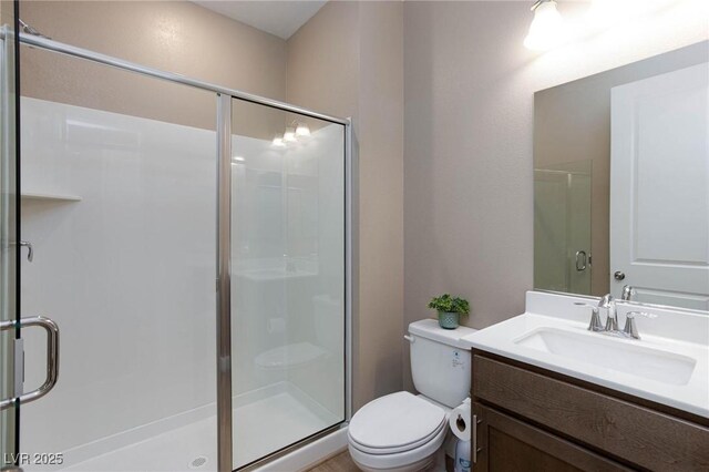 8873 Howell St, Las Vegas, NV 89166 - bathroom featuring a stall shower, vanity, and toilet
