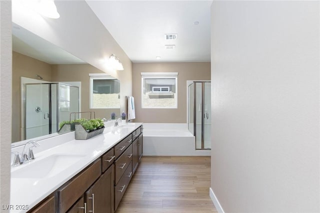 8873 Howell St, Las Vegas, NV 89166 - full bathroom featuring wood finished floors, a stall shower, a bath, and healthy amount of natural light