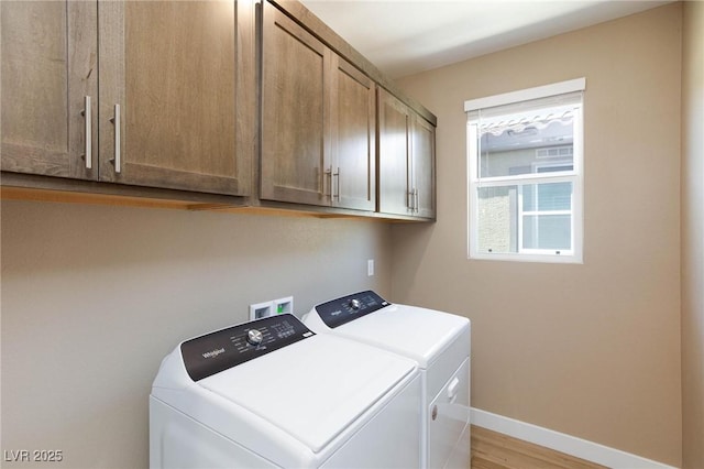 8873 Howell St, Las Vegas, NV 89166 - washroom featuring cabinet space, independent washer and dryer, baseboards, and light wood finished floors