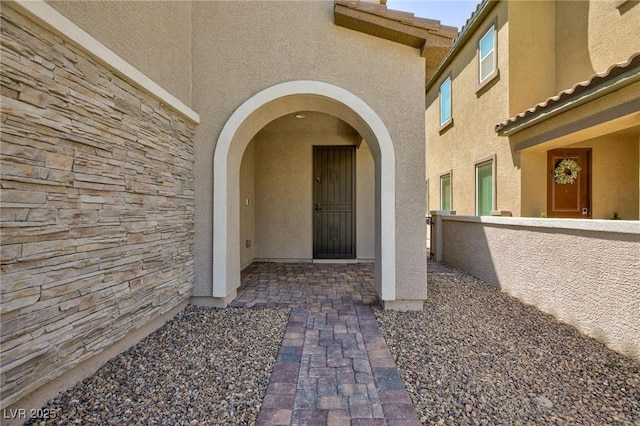 8873 Howell St, Las Vegas, NV 89166 - property entrance featuring stucco siding and a tile roof
