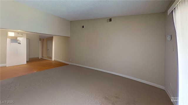 unfurnished living room featuring baseboards and carpet