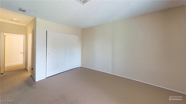 unfurnished bedroom featuring carpet floors and a closet