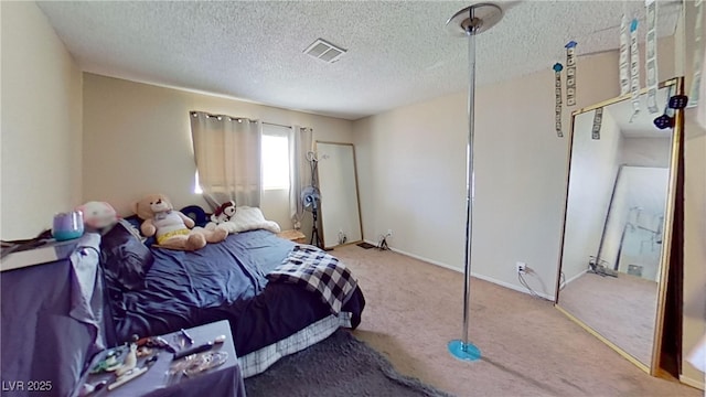 bedroom with carpet, a textured ceiling, and baseboards