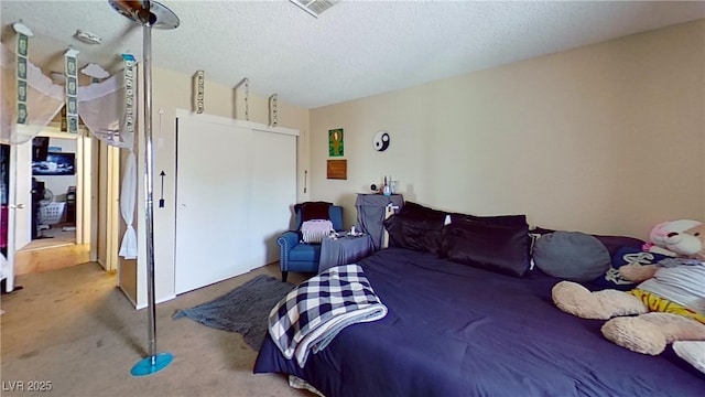 carpeted bedroom with a textured ceiling
