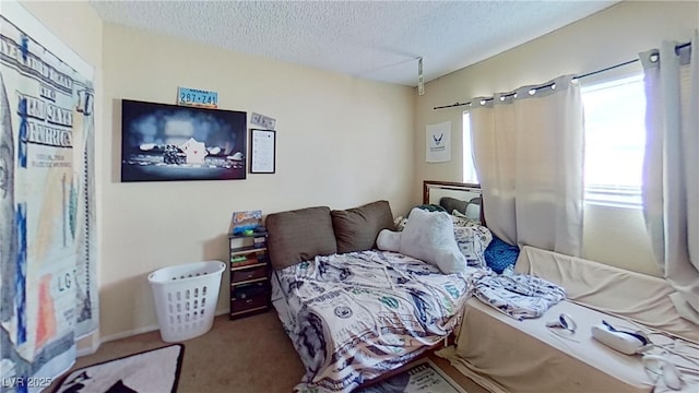 carpeted bedroom featuring a textured ceiling