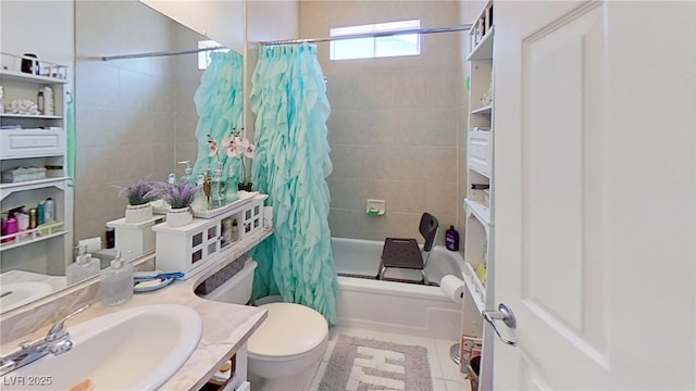 full bath featuring toilet, shower / bath combo with shower curtain, vanity, and tile patterned floors