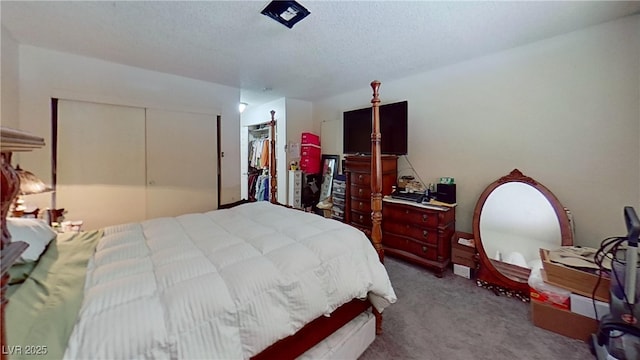 carpeted bedroom with a closet and a textured ceiling