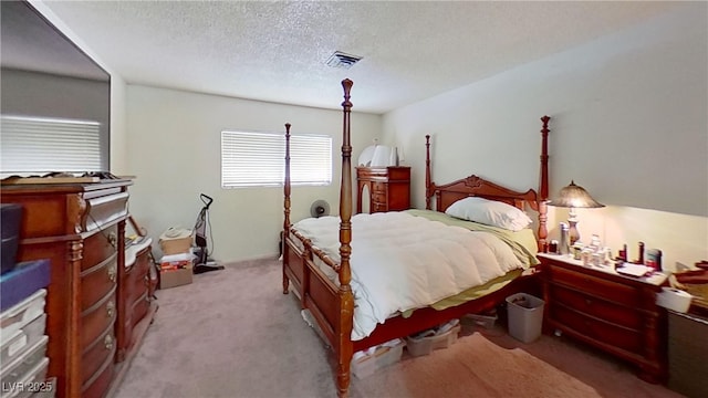 carpeted bedroom featuring a textured ceiling