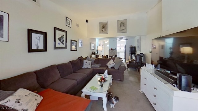 living area featuring carpet floors and ceiling fan