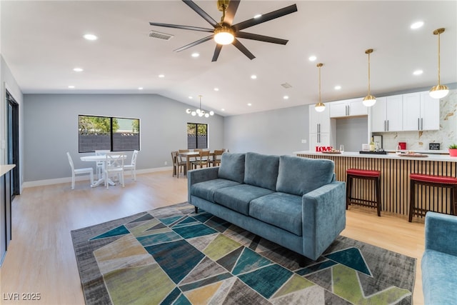 living room with light wood-style flooring, a ceiling fan, lofted ceiling, recessed lighting, and baseboards