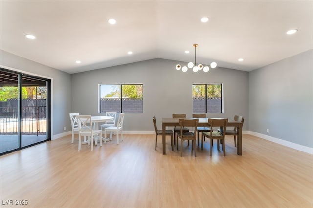 dining room with healthy amount of natural light, a chandelier, light wood-type flooring, recessed lighting, and lofted ceiling