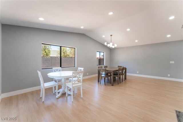 dining space with a chandelier, vaulted ceiling, light wood finished floors, recessed lighting, and baseboards