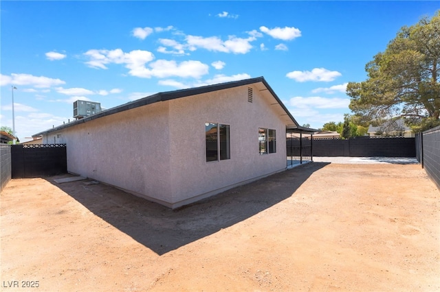view of home's exterior with a fenced backyard, stucco siding, and a patio
