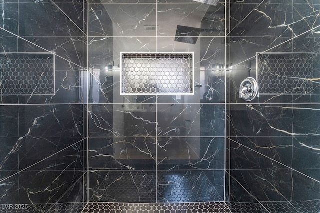 bathroom with a tile shower
