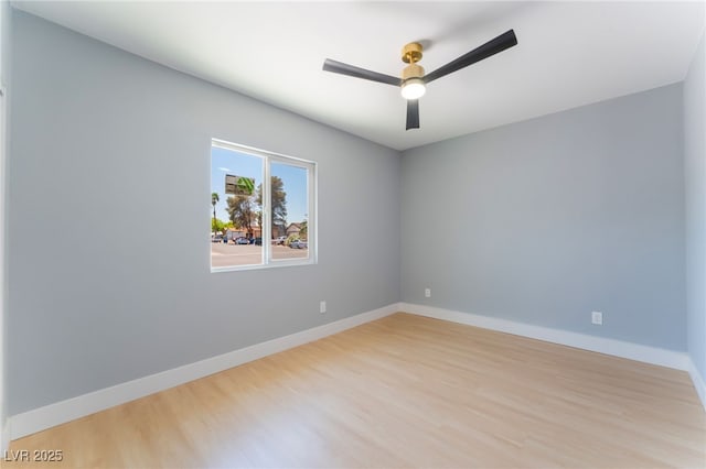 unfurnished room with light wood finished floors, ceiling fan, and baseboards