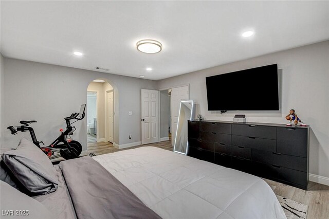 2224 Lucerne Ct, Henderson, NV 89014 - bedroom featuring arched walkways, light wood-style floors, baseboards, and recessed lighting