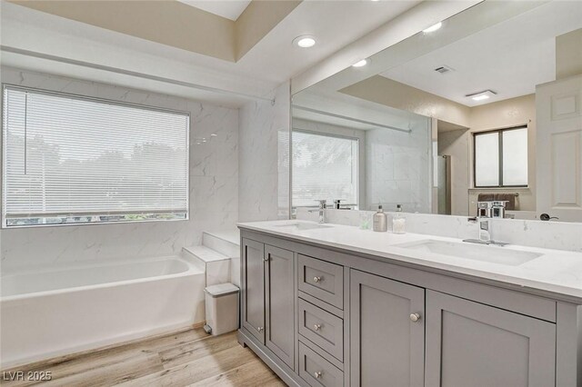 2224 Lucerne Ct, Henderson, NV 89014 - full bath featuring wood finished floors, a garden tub, double vanity, and a stall shower