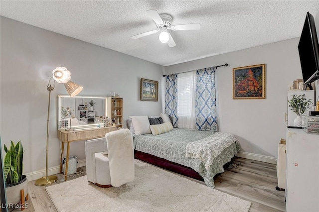 2224 Lucerne Ct, Henderson, NV 89014 - bedroom with wood finished floors, a textured ceiling, baseboards, and ceiling fan